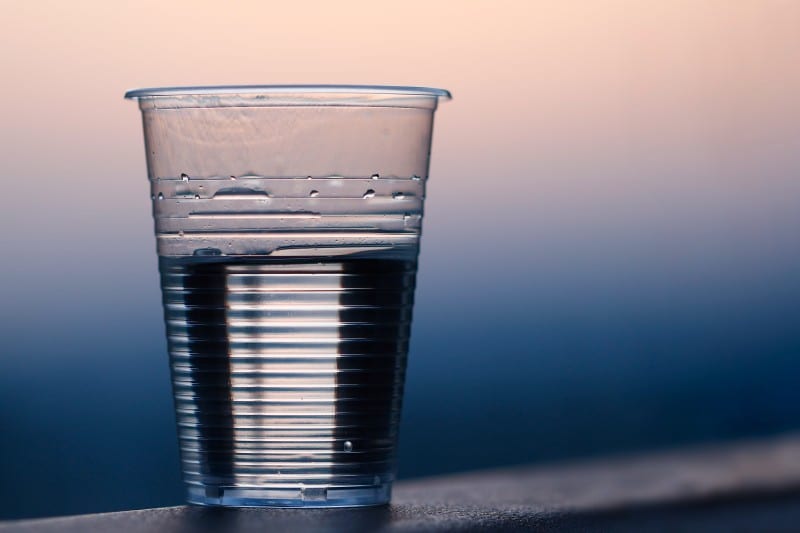 cup of water sitting on table crucial to maintain a beauty regime