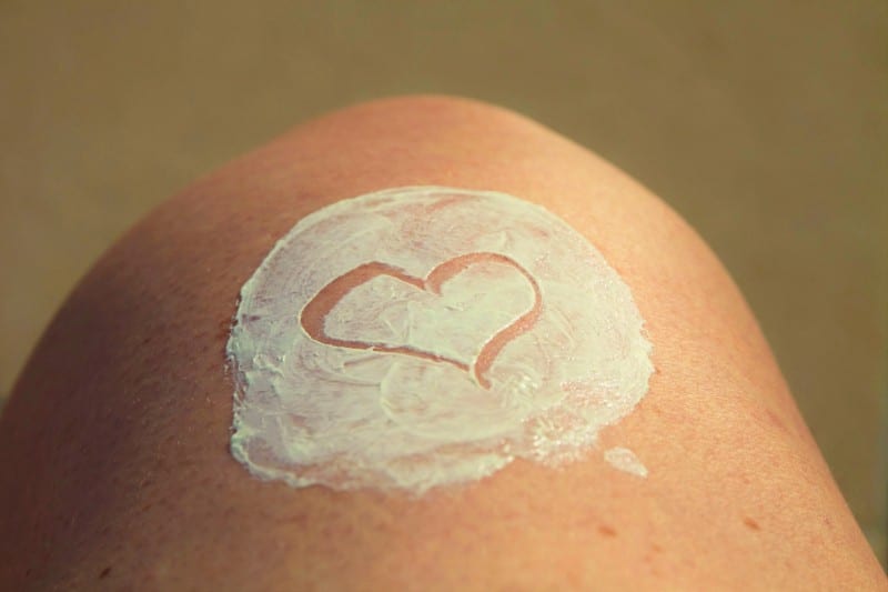 heart in sunscreen on leg used to maintain a beauty regime