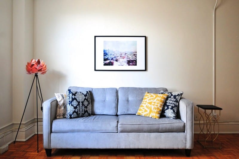grey couch with photo on wall