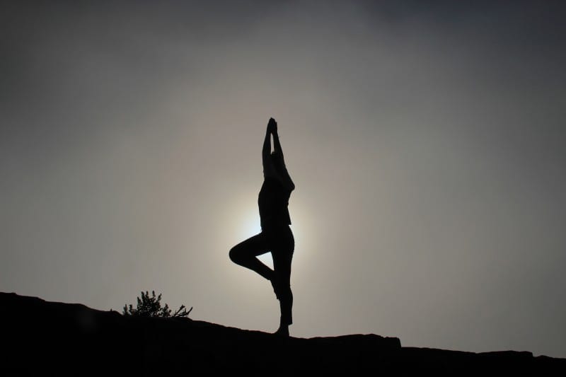 black and white yoga pose silhouette to boost your confidence